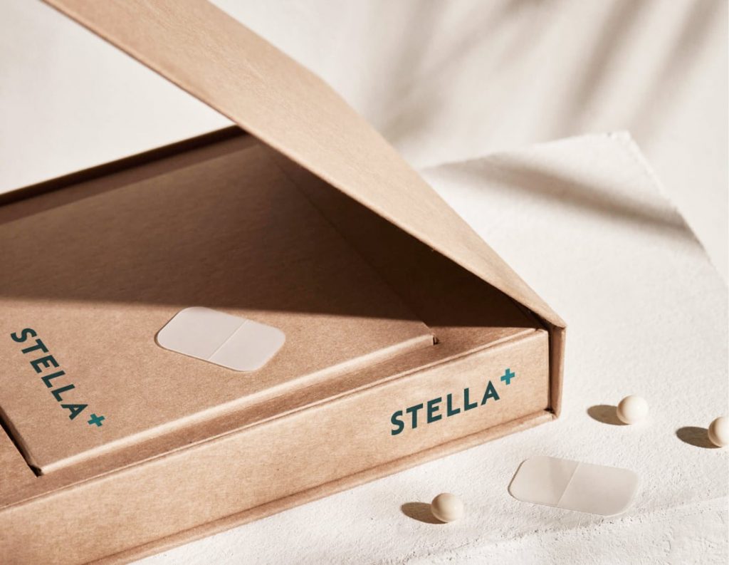 A cardboard box next to some medication, the box reads "Stella+"