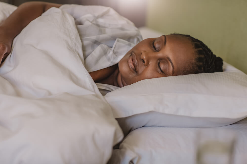 close up of woman sleeping in bed