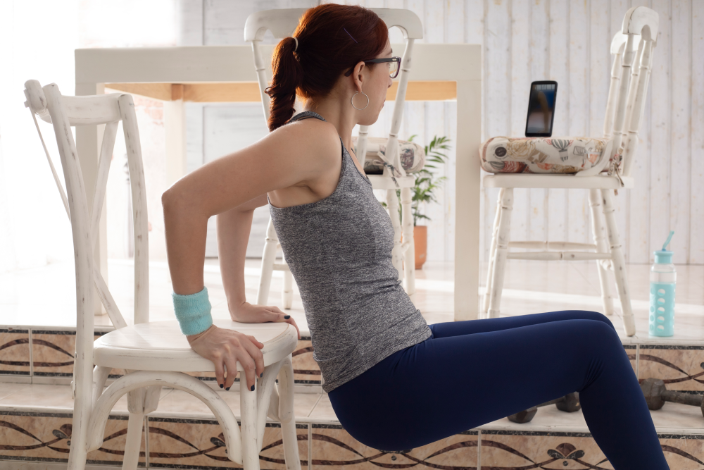A woman in athletic clothes exercising at home