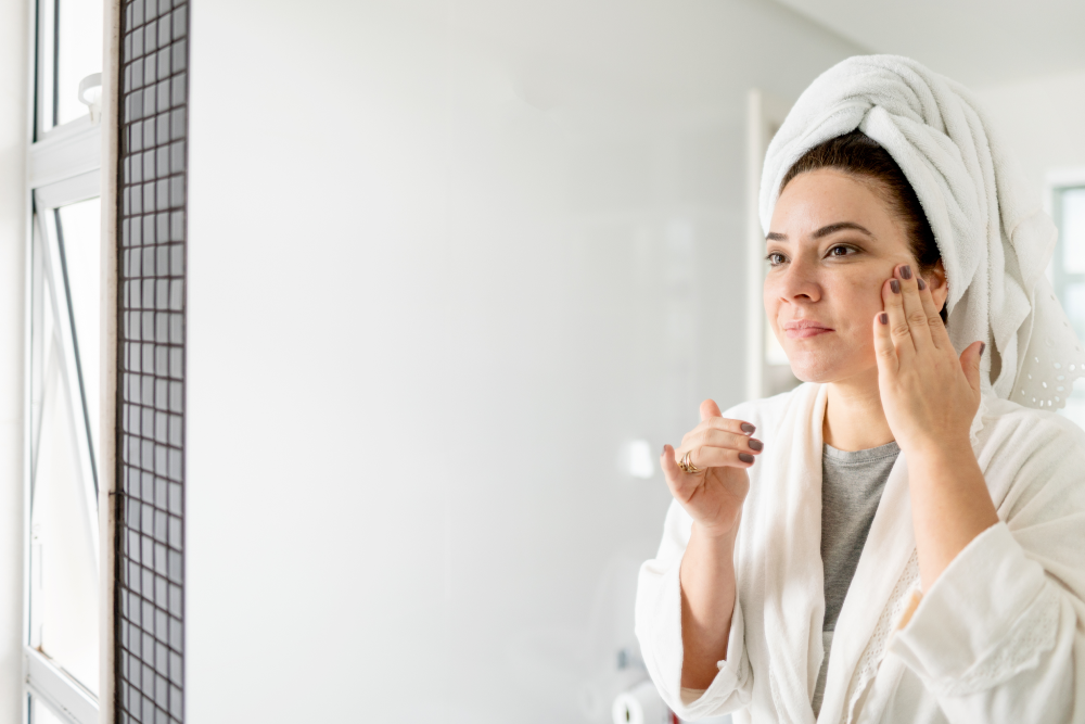 Woman applying skincare in the mirror