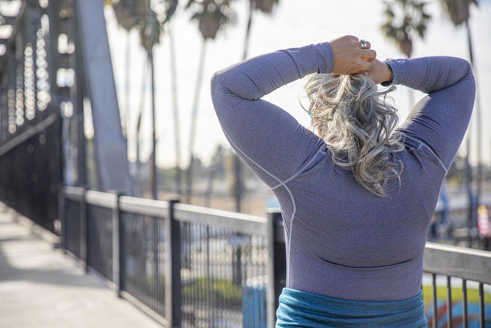 A senior woman fixing her hair