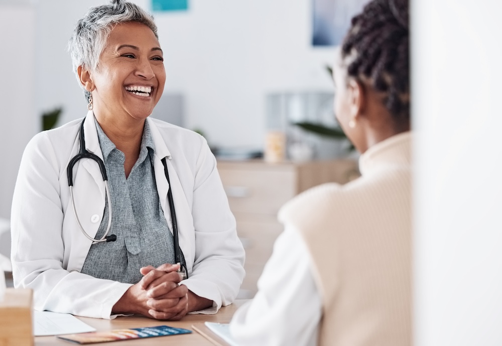 Smiling Doctor consulting a patient for healthcare help, feedback or support