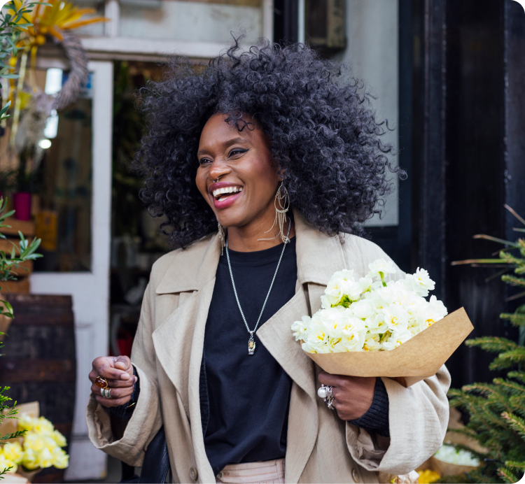 smiling woman holding fresh cut flowers